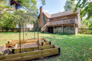 a garden in front of a house at Overland Park Home with Fenced-In Yard and Gas Grill! in Overland Park