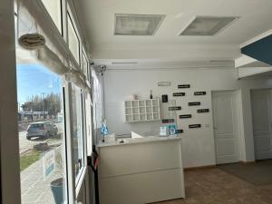 a kitchen with a counter in a room with a window at Hotel Kelman in Perito Moreno