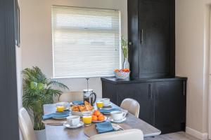 a dining room table with a bowl of fruit on it at Colt Park Cottage in Ulverston