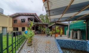 a house with a fence and a patio at The River Village Retreat Kiulu in Tamparuli