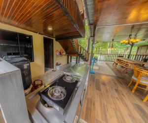 a kitchen with a stove top in a house at The River Village Retreat Kiulu in Tamparuli