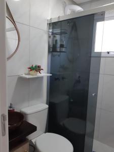 a bathroom with a toilet and a shower and a sink at Apartamento Cantinho do Aconchego-Nova Petrópolis in Nova Petrópolis +11 photos
