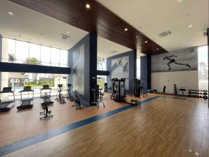 a gym with treadmills and exercise equipment in a building at Departamento a pie de playa en Camino al Mar in Mazatlán