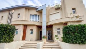 a large building with stairs in front of it at North coast Sedra resort villa قرية سيدرا الساحل الشمالي in Alexandria