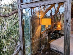 a bedroom in a tree house with a window at Magical Treehouse in Lagos