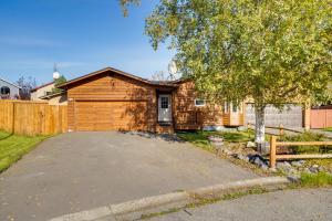 a house with a garage and a fence at Pet-Friendly Anchorage Home - 8 Mi to Downtown! in Anchorage