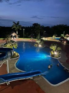 a swimming pool at a resort at night at Casa vacacional en Pedro Vicente Maldonado in Pedro Vicente Maldonado