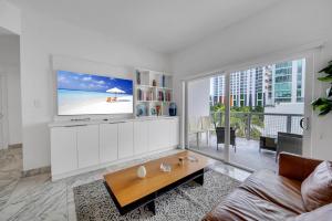 a living room with a tv and a couch at Subtle 2 Bed in Edgewater near Downtown With Free Parking in Miami