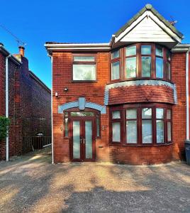 a red brick house with a front door at Full Home in Heywood Street near Cheetham Hill in Manchester
