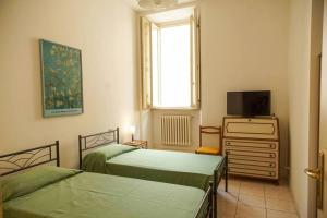 Ένα ή περισσότερα κρεβάτια σε δωμάτιο στο Il Carapace - Appartamento nel cuore di Foligno
