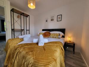 sypialnia z łóżkiem z ręcznikami w obiekcie Stylish Flat - Ideal location for Contractors, Families, Relocators, Business, Free Parking, Long-Stays w mieście Banbury