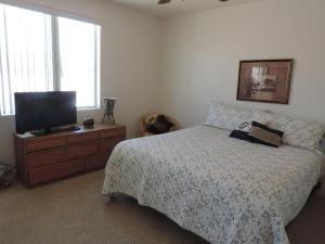a bedroom with a bed and a flat screen tv at Alibi-Step to open desert in Lake Havasu City