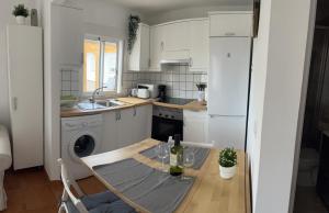 a small kitchen with a table and a sink at Tantulia Bungalows Tamaragua Tenerife in Arona