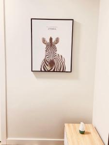 a picture of a zebra on a wall at Entire 3 bedroom house in Edmonton