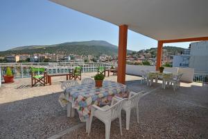 a table and chairs on a roof with a view at To Pithari in Skala Marion