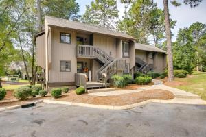 a house with a staircase in front of it at Pinehurst Condo Rental Near Golf with Pool Access! in Pinehurst