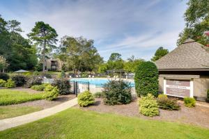 a swimming pool in a yard with a fence at Pinehurst Condo Rental Near Golf with Pool Access! in Pinehurst
