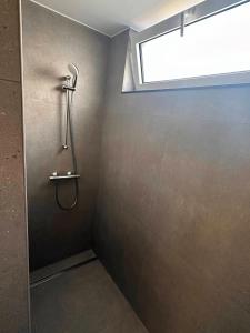 a shower in a bathroom with a window at Akuta City Flat Leuven in Leuven