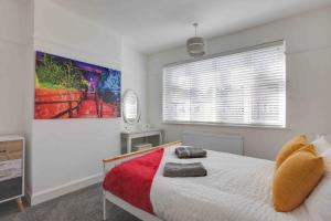 a bedroom with a bed and a large window at Grove House Southend on Sea in Southend-on-Sea
