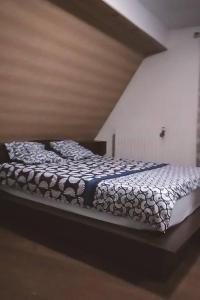 a bedroom with a bed in a room with at Appartement au pied du château in Montbéliard