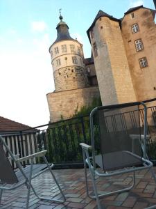 two chairs sitting in front of a castle at Appartement au pied du château in Montbéliard