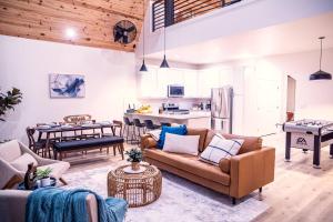 a living room with a couch and a kitchen at Gruene Daze Chalet - Stylish Aframe - Escape the Ordinary in New Braunfels