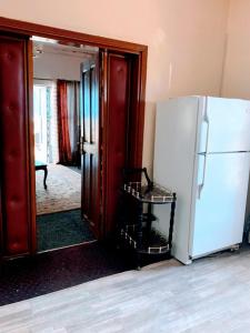 a kitchen with a white refrigerator and a mirror at VILLA ÉMERAUDE in Yaoundé