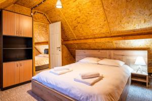 a bedroom with a large bed in a room at Woods Retreat in Râu de Mori +40 photos