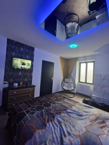 a bedroom with a large bed and a blue ceiling at Suite GOLD Mulhouse in Mulhouse