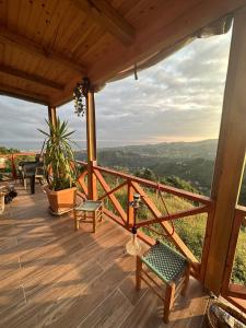a deck with chairs and a view of the valley at Tenta bungalov in Rize