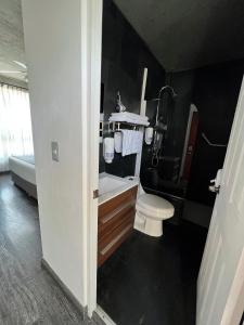 a bathroom with a toilet and a sink and a tub at Hotel Puerto Chinchorro in Arica +30 photos