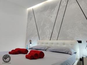 a bed with two red pillows on top of it at Domus Iulia - Colosseo in Rome