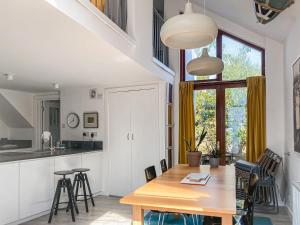 a kitchen and dining room with a wooden table and chairs at The Old Workshop in Appledore