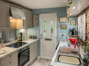 cocina con fregadero y encimera en Acorn Cottage en Linton