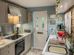 a kitchen with a sink and a counter top at Acorn Cottage in Linton