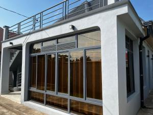 a building with large windows on the side of it at Ruhuka House - connexion STARLINK privée & gratuite in Bujumbura