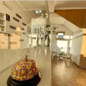 a room with a counter with vases and flowers on it at Hotel Kelman in Perito Moreno