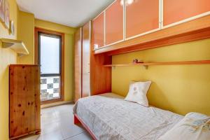 a small bedroom with a bed and a window at Compostella Beach - 2 bedroom in Arona