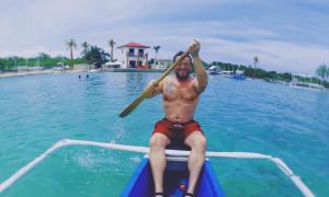 a man is sitting on a boat in the water at PRIVATE COLLECTION 贅沢 Jade's Beach Villa 별장 Cebu-Olango An exclusive private beach secret in Lapu Lapu City