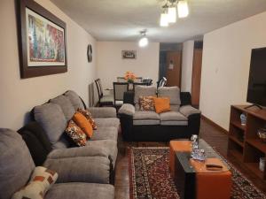 a living room with two couches and a tv at Amplio y lindo departamento. in Arequipa
