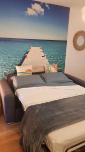 a row of beds on a pier in the water at Les Studios de Fiori - Studios et Appartement T2 - Cala Rossa - proche Porto Vecchio in Lecci