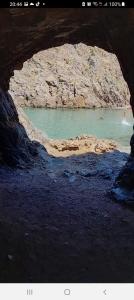 een uitzicht op een grot met een zwembad met water bij B&B Sensorial Experience in Villamassargia