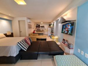 a bedroom with a bed and a couch and a living room at Tabatinga Residence Flat Family Kids 04 in Conde +12 photos