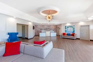 a living room with a couch and red pillows at Best Western Summit Inn in Niagara Falls