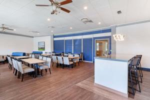 a dining room with tables and chairs and a ceiling fan at Best Western Summit Inn in Niagara Falls