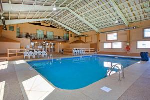 a large swimming pool in a building with chairs at Best Western Summit Inn in Niagara Falls