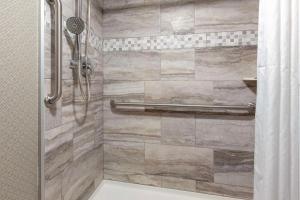 a bathroom with a shower with a toilet at Best Western Summit Inn in Niagara Falls