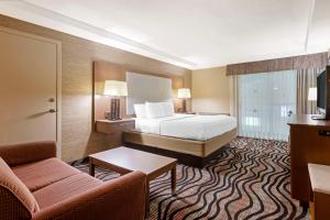 a hotel room with a bed and a couch at Best Western Summit Inn in Niagara Falls