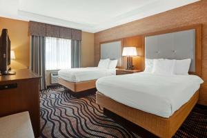 a hotel room with two beds and a television at Best Western Summit Inn in Niagara Falls