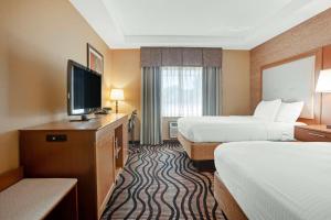 a hotel room with two beds and a flat screen tv at Best Western Summit Inn in Niagara Falls